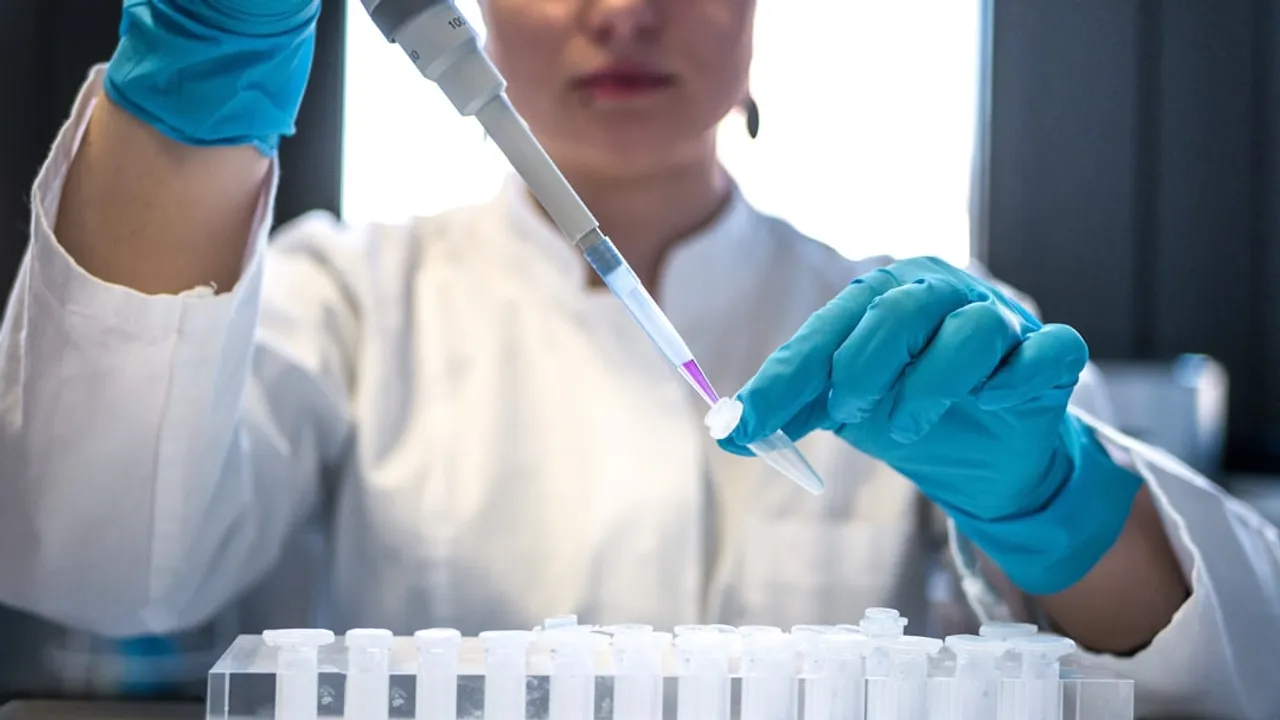 scientist using pipette with test tubes in lab