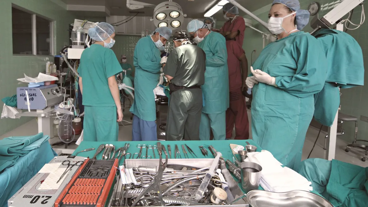 Medical team conducting surgery in a sterile operating room with surgical tools on display.