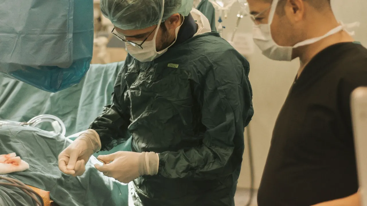 Surgeons and medical staff in a sterile operating room conducting a surgical procedure.