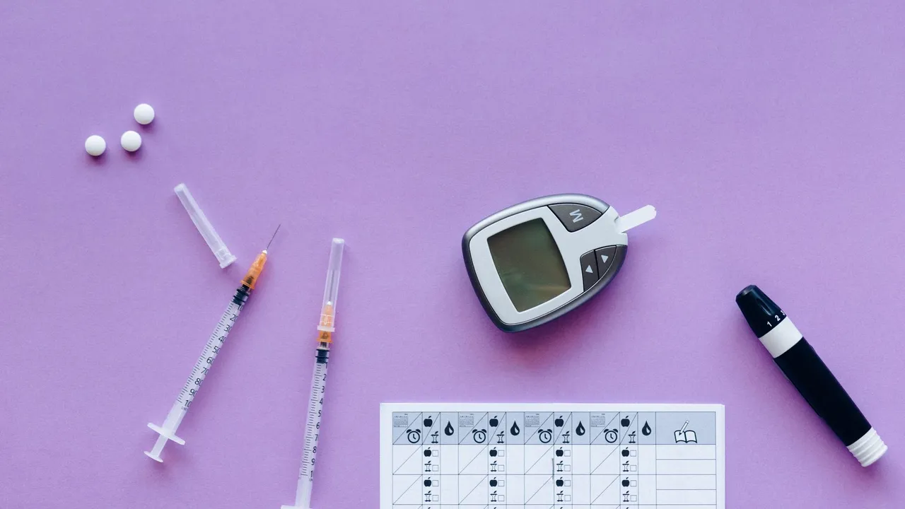 Flat lay of diabetes management tools including glucometer, syringes, and pills on purple background.