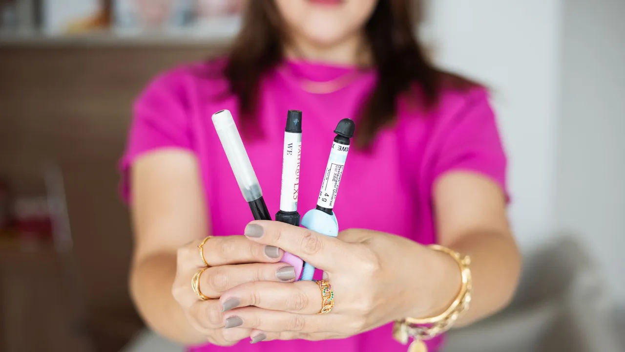 Close-up of a woman's hands holding insulin pens. Perfect for health and diabetes-related content.